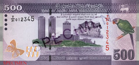 At the center of the front of the LKR 500 note, the World Trade Center twin towers and the Bank of Ceylon head office are depicted. To the right of this image is the “Lankathilake Viharaya”. The bird to the right of the note is the Sri Lankan Emerald Collared Parakeet and the butterfly to the left is the Ceylon Indigo Royal.